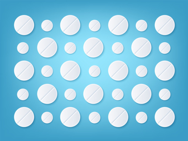 Two rows of alternating white baby aspirin and white adult aspirin pills against a blue background 